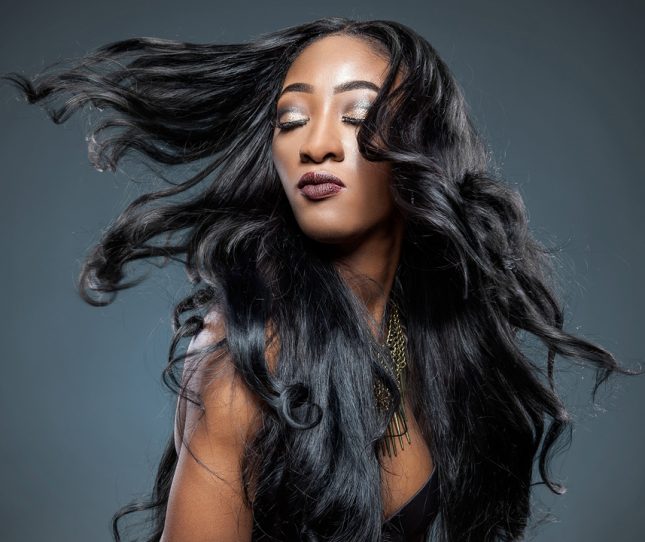 Black beautiful woman with long luxurious shiny hair